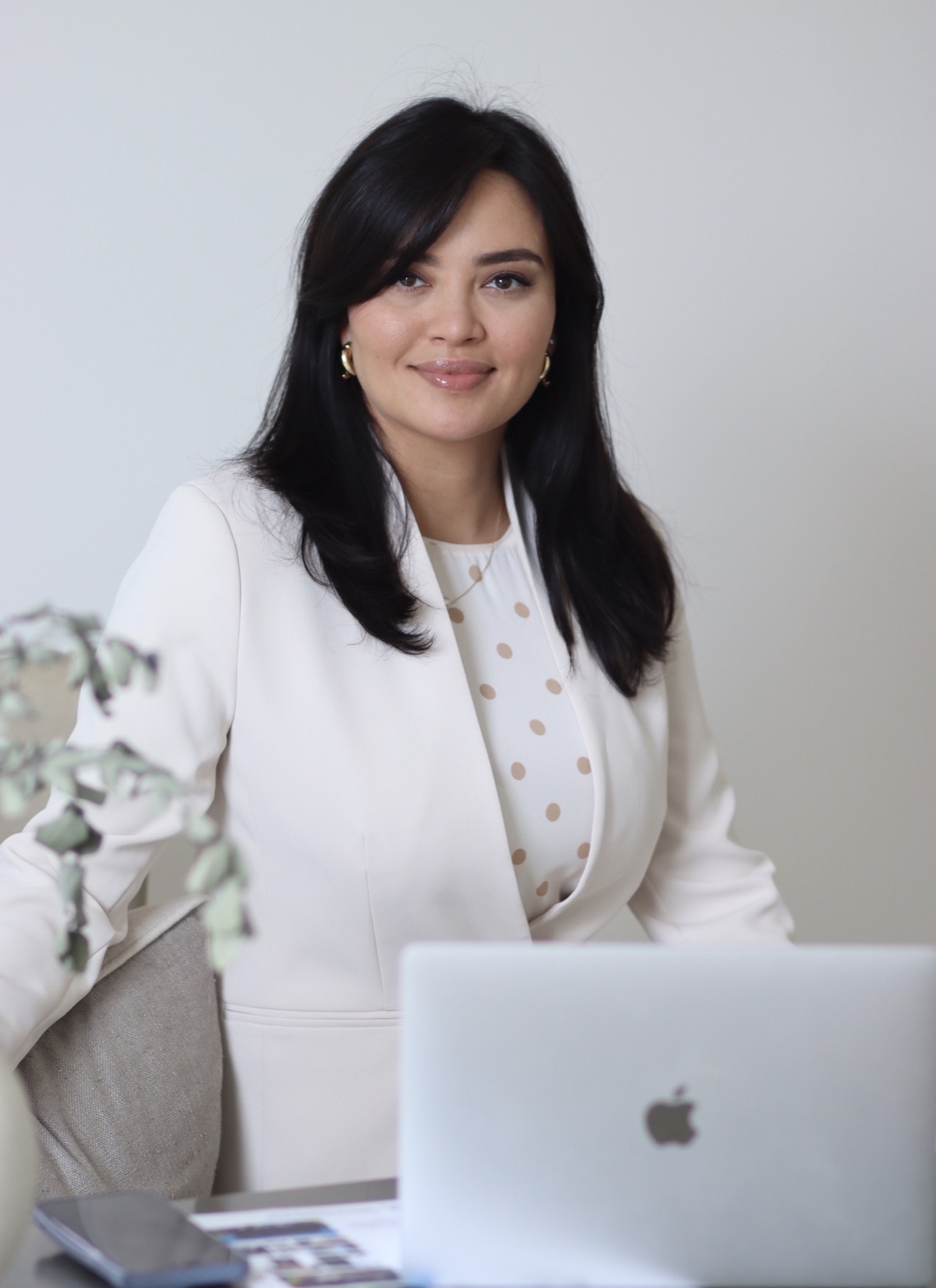 Shakhlo seated at her desk, smiling